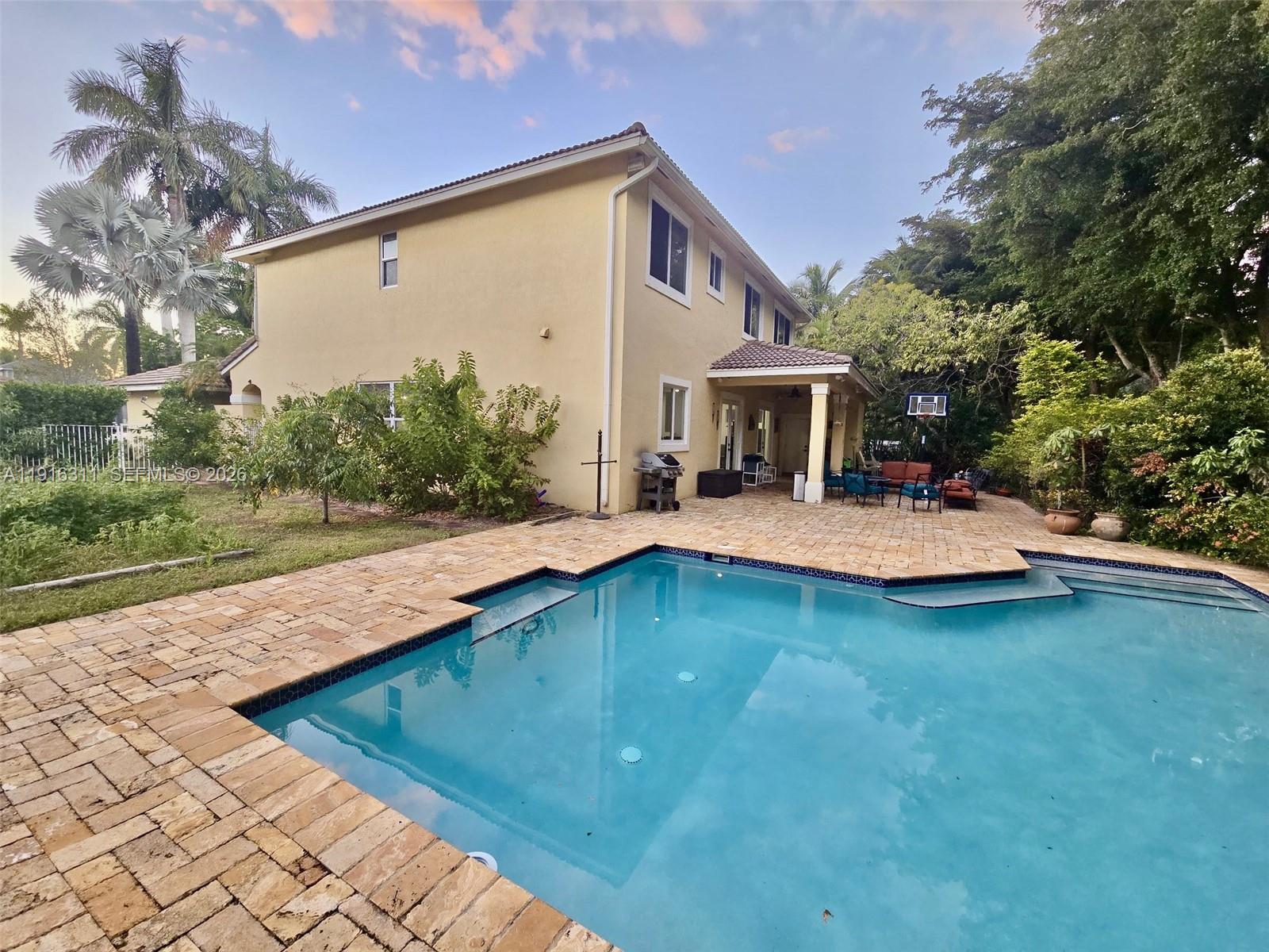 2019 Harbor View Circle Weston, FL 33327 - Photo 23 of 29 a view of a house with pool and chairs