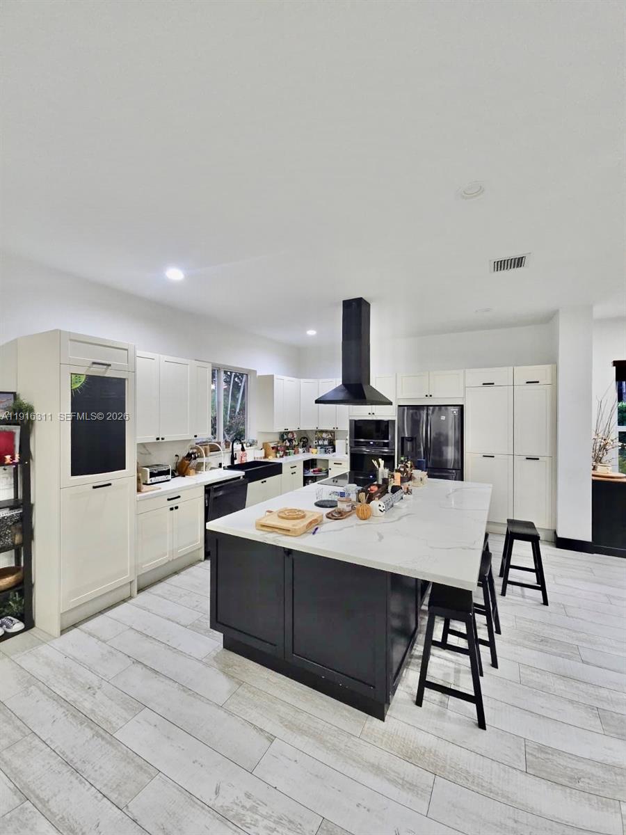 2019 Harbor View Circle Weston, FL 33327 - Photo 4 of 29 a large white kitchen with sink a microwave and cabinets