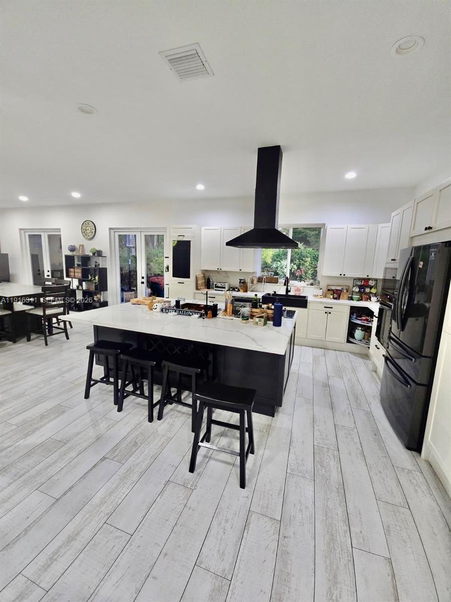 2019 Harbor View Circle Weston, FL 33327 - Photo 7 of 29 a living room with stainless steel appliances kitchen island granite countertop furniture and a kitchen view