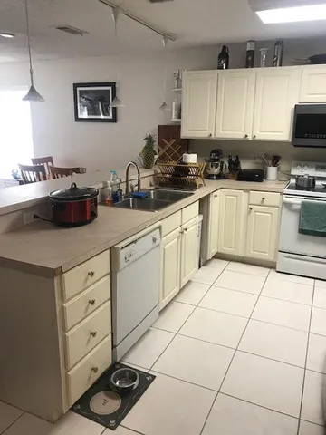 a kitchen with cabinets and appliances