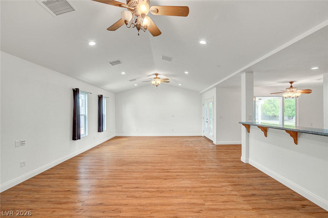 1810 Pinto Road Henderson, NV 89002 - Photo 16 of 53 Vast living space with vaulted ceilings and beautiful hardwood-style flooring awaits your personalized touch.
