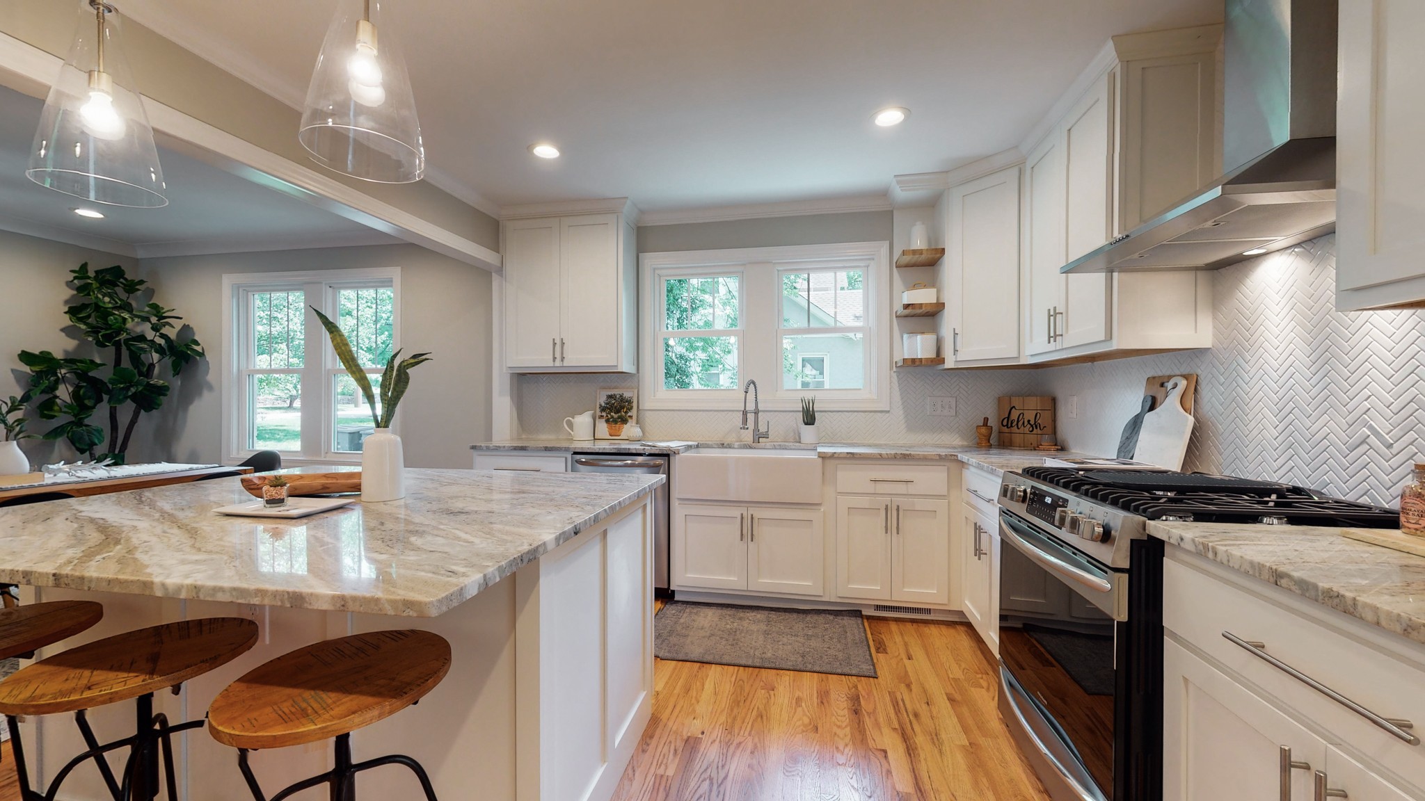 4109 Murphy Road Nashville, TN 37209 - Photo 11 of 31 a kitchen with a stove white cabinets a sink dishwasher and a stove with wooden floor
