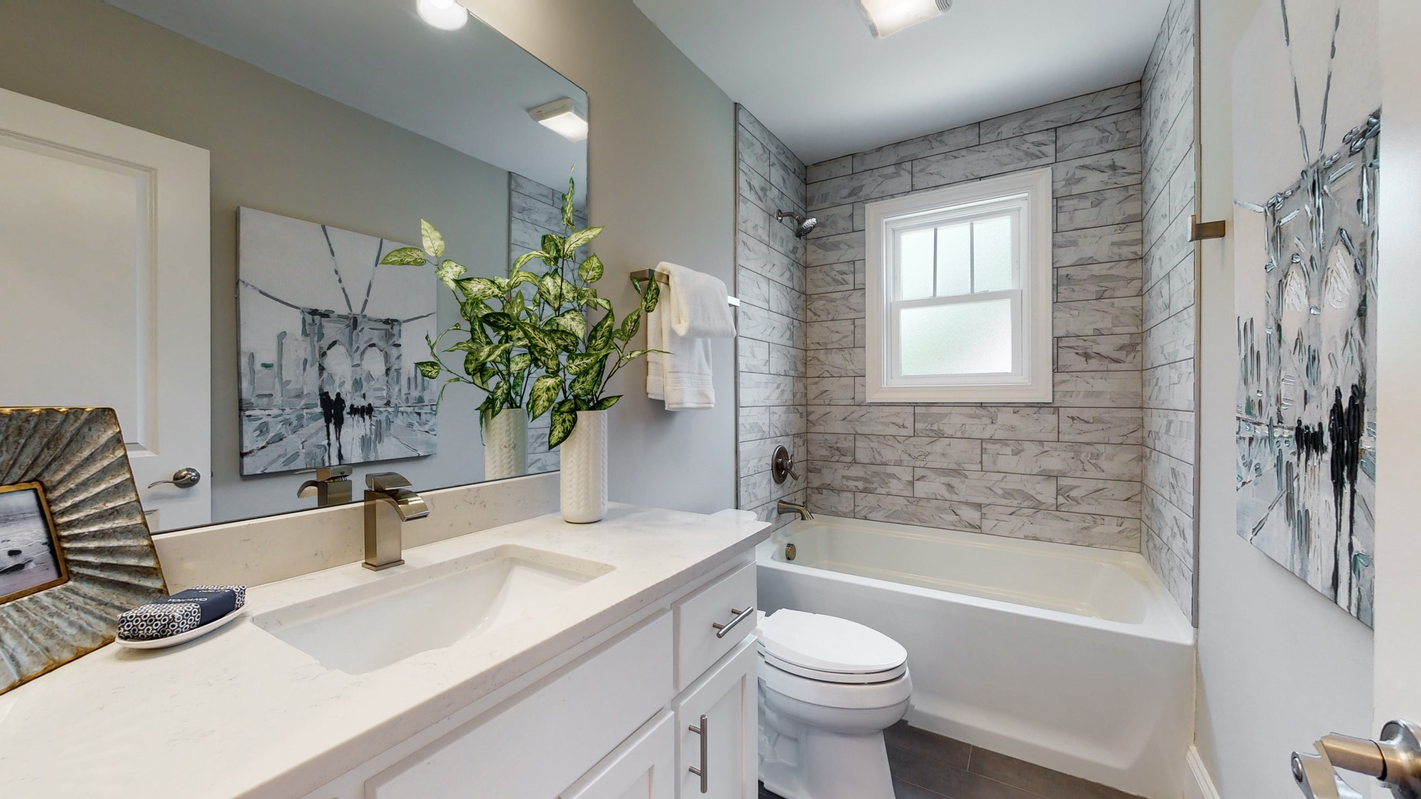 4109 Murphy Road Nashville, TN 37209 - Photo 22 of 31 a bathroom with a granite countertop sink a toilet a mirror a vanity a bathtub and shower