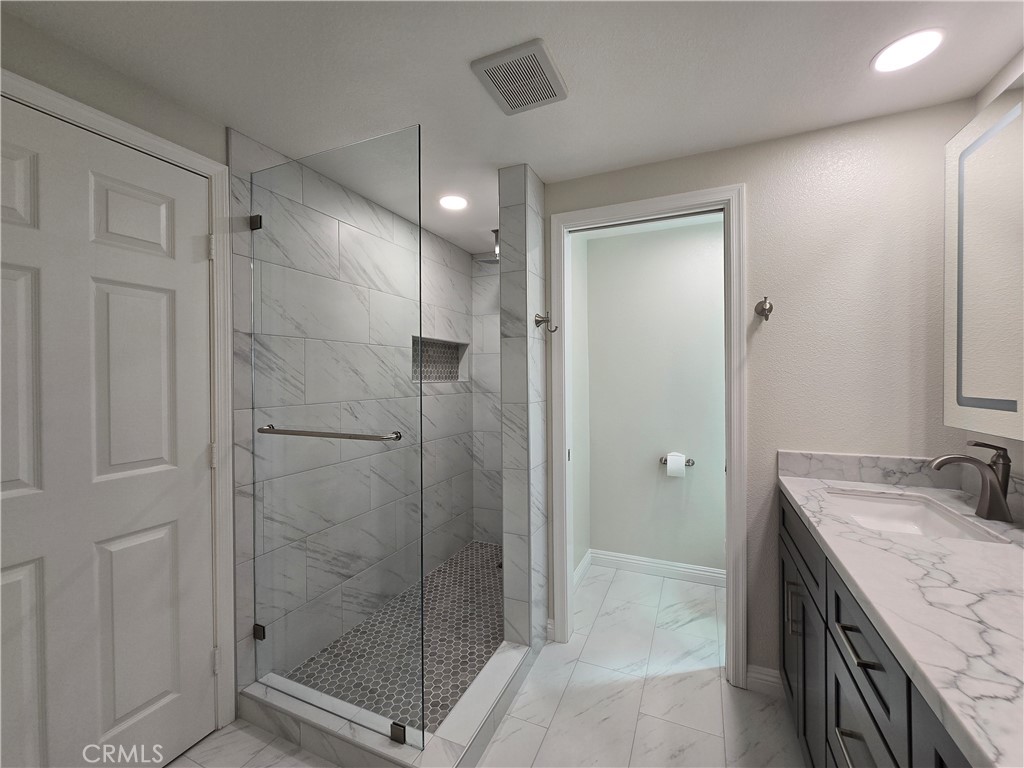 6846 Barkwood Road Riverside, CA 92506 - Photo 11 of 27 a bathroom with a shower and a sink