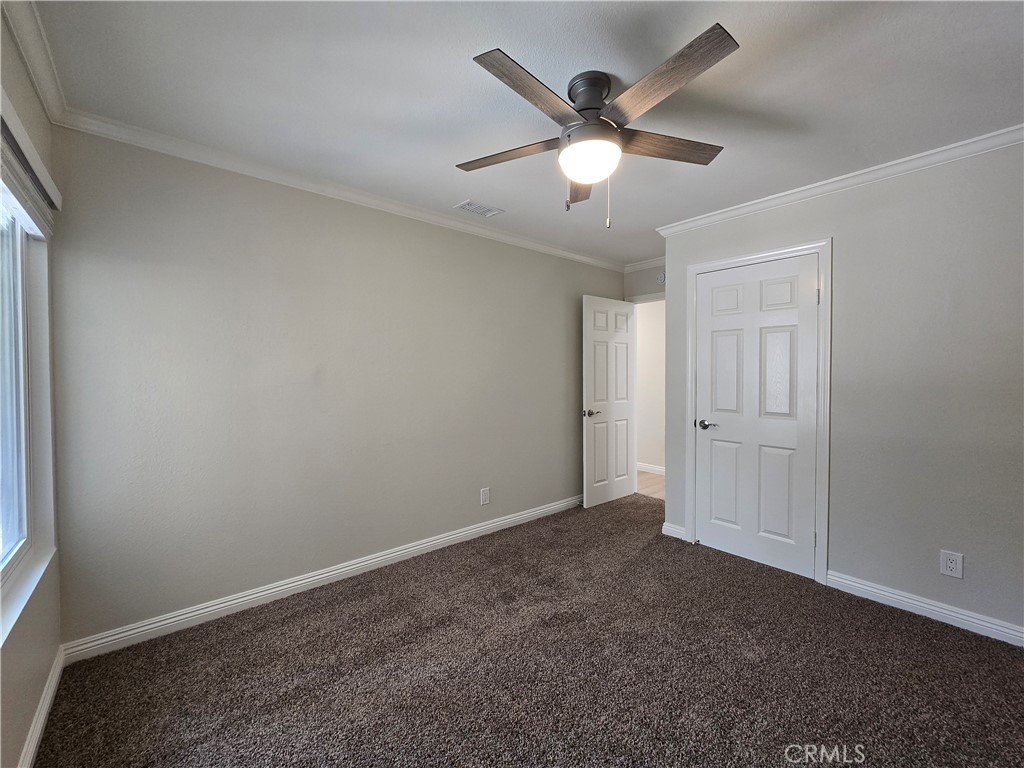 6846 Barkwood Road Riverside, CA 92506 - Photo 14 of 27 an empty room with closet and windows