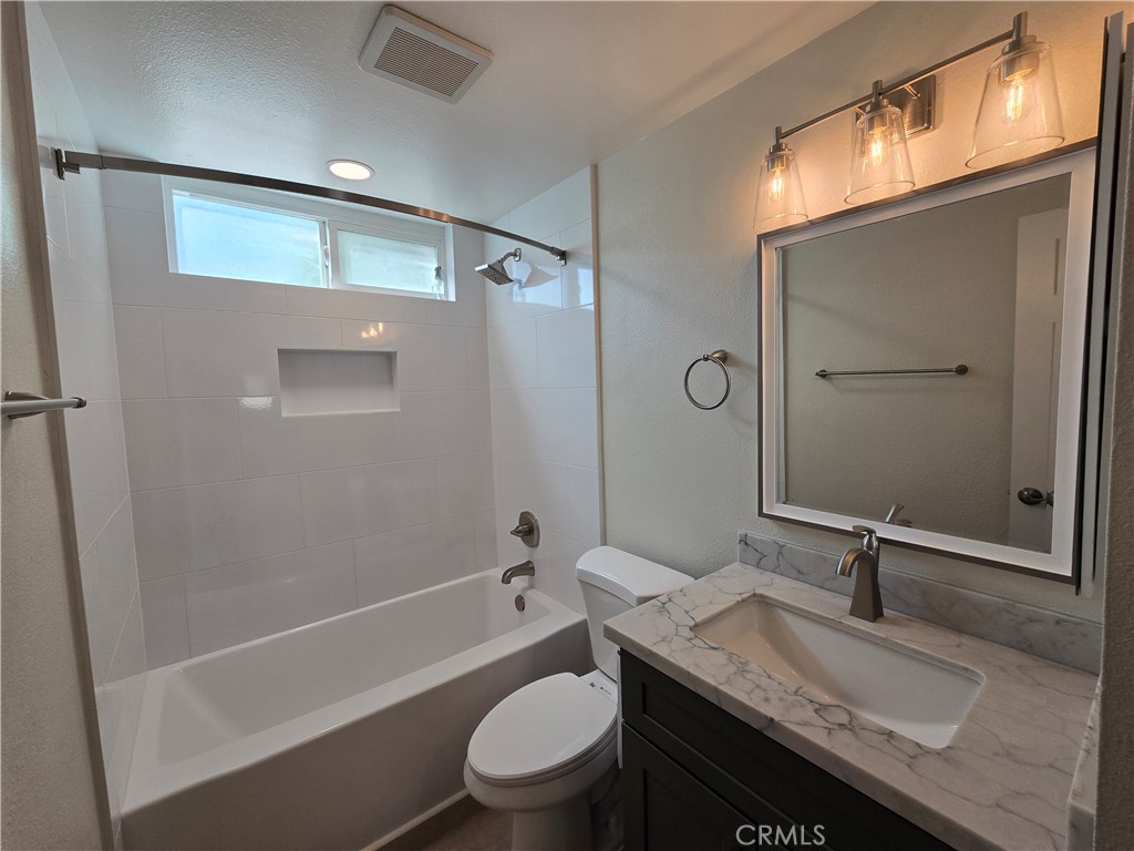 6846 Barkwood Road Riverside, CA 92506 - Photo 15 of 27 a bathroom with a granite countertop sink toilet and shower