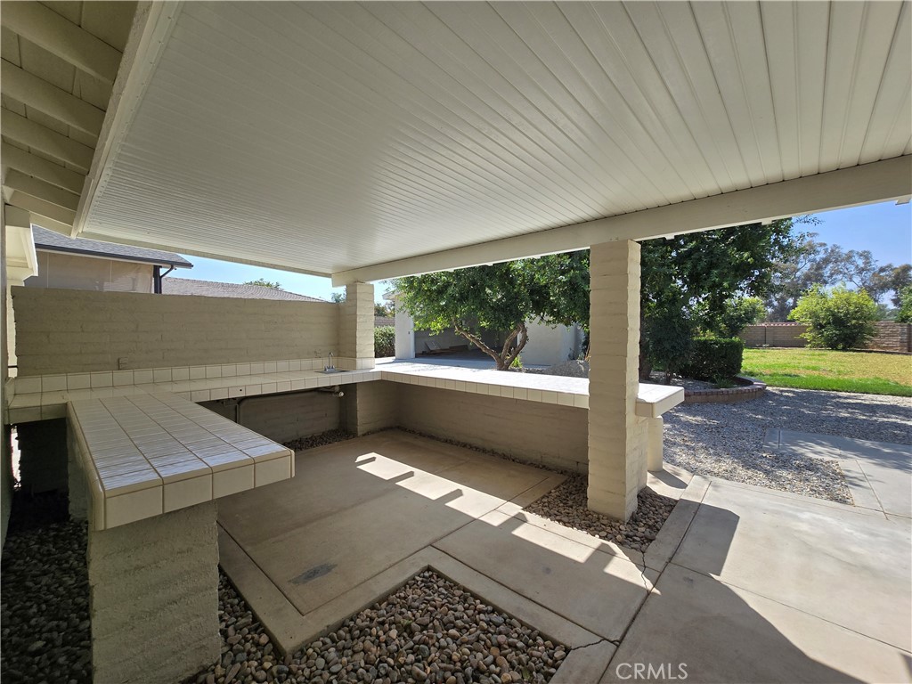 6846 Barkwood Road Riverside, CA 92506 - Photo 25 of 27 a view of a porch with wooden floor and yard