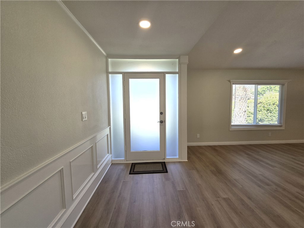 6846 Barkwood Road Riverside, CA 92506 - Photo 3 of 27 an empty room with wooden floor and windows
