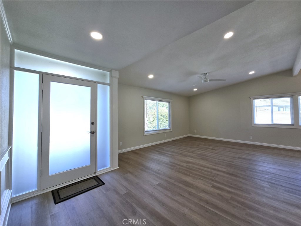 6846 Barkwood Road Riverside, CA 92506 - Photo 4 of 27 an empty room with wooden floor and windows