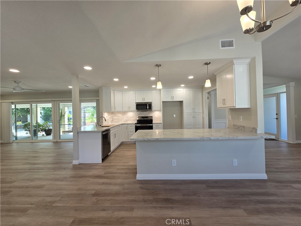 6846 Barkwood Road Riverside, CA 92506 - Photo 6 of 27 a view of kitchen with kitchen island and living room