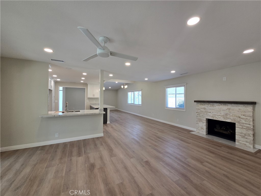 6846 Barkwood Road Riverside, CA 92506 - Photo 7 of 27 a view of an empty room and kitchen with wooden floor
