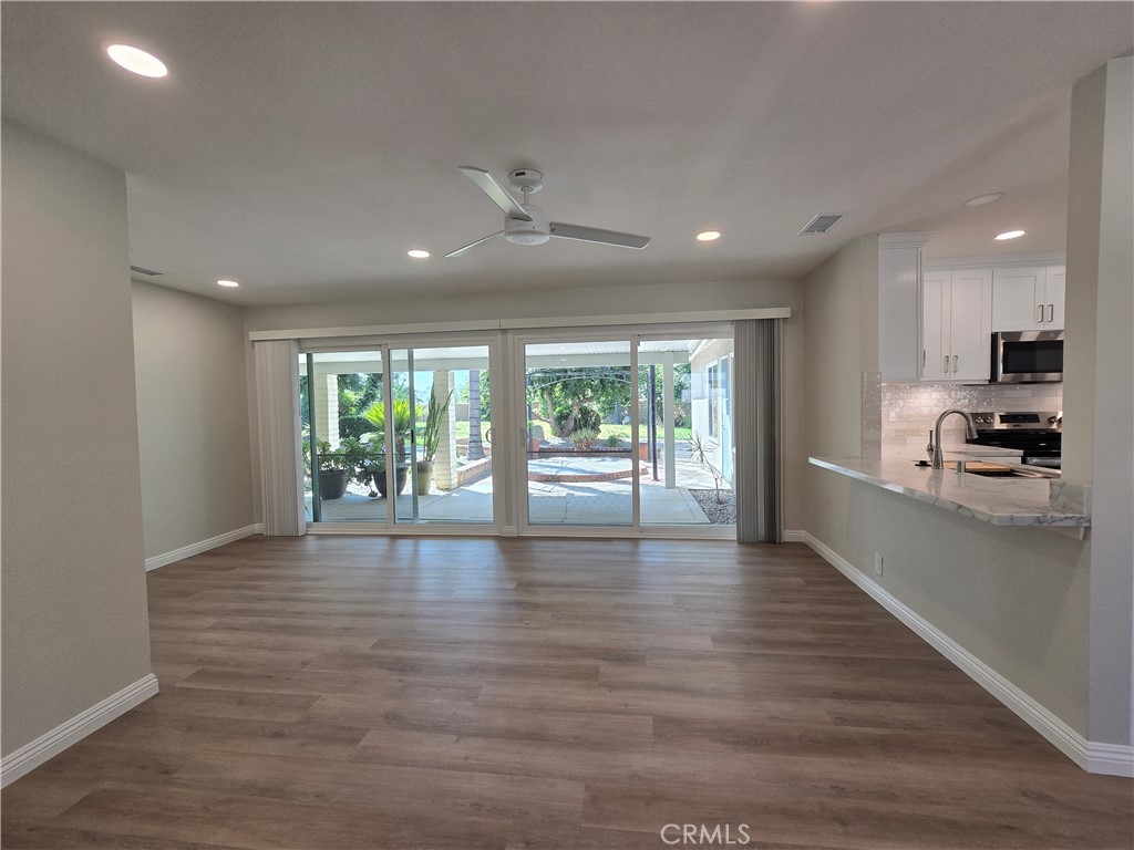 6846 Barkwood Road Riverside, CA 92506 - Photo 8 of 27 a view of kitchen with kitchen island wooden floor and window