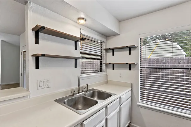 a kitchen with a sink and cabinets
