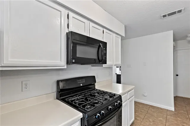 a kitchen with stainless steel appliances a microwave and a sink