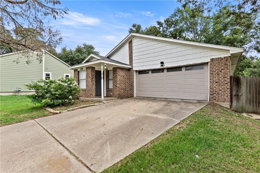 2208 Lobo Drive Bryan, TX 77807 - Photo 2 of 23 a white house with a small yard and a large parking space