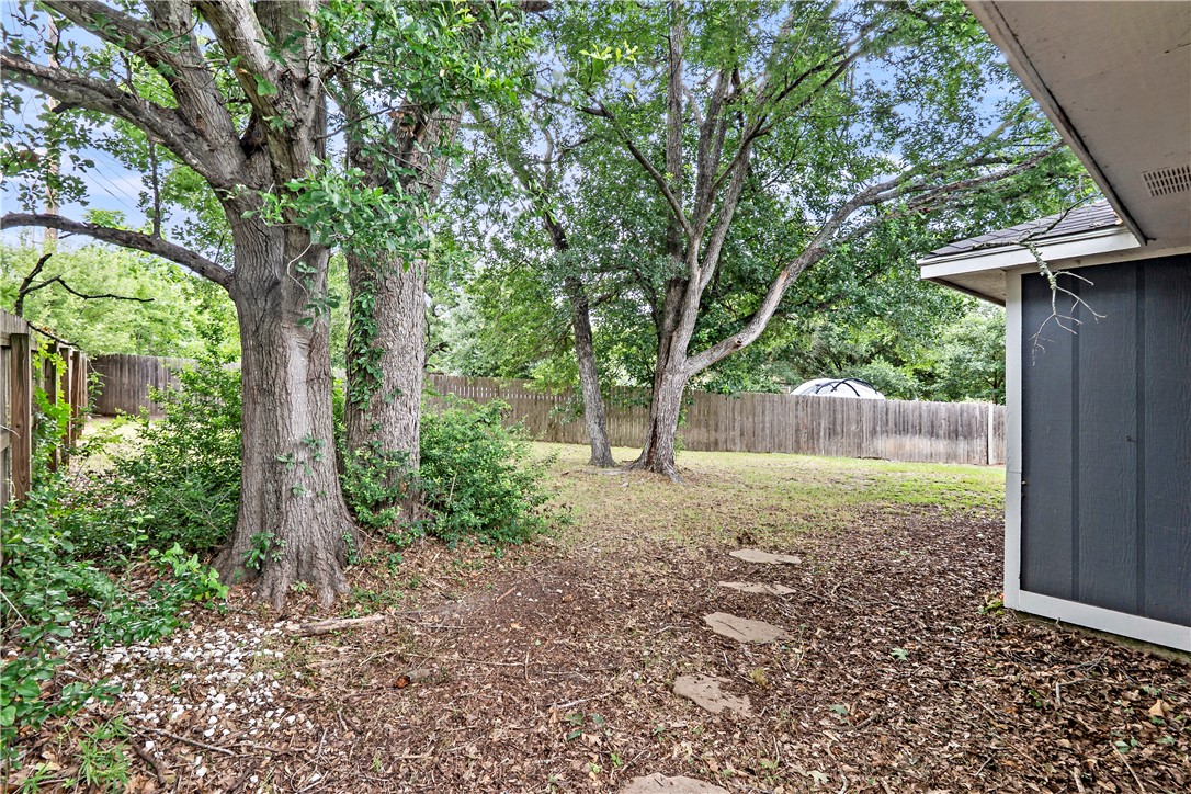 2208 Lobo Drive Bryan, TX 77807 - Photo 22 of 23 a view of backyard with large trees and plants