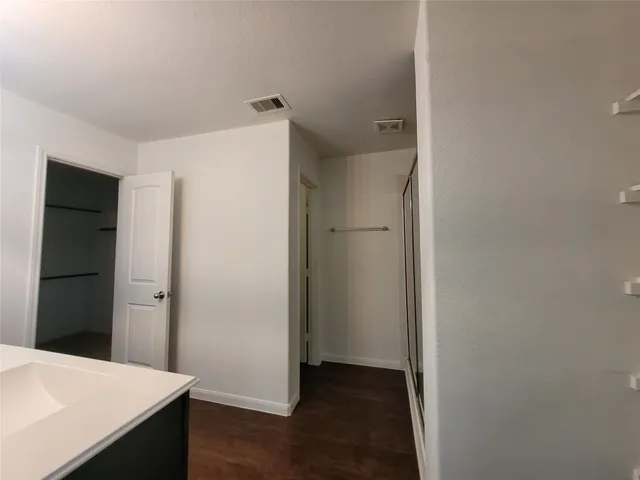 a view of a hallway with wooden floor