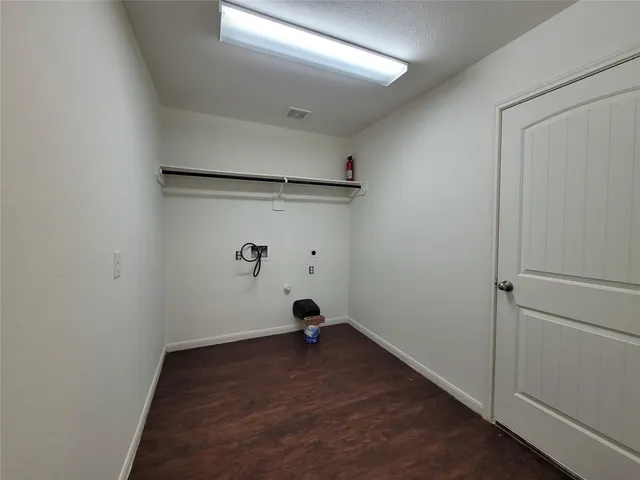 a view of a room with wooden floor and fan