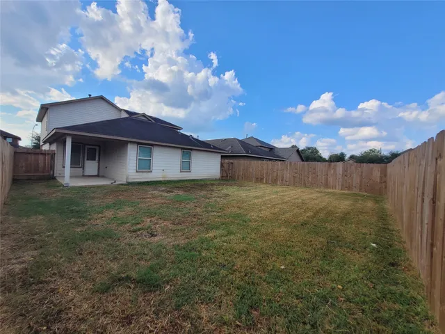 a view of a house with a backyard