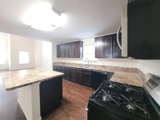 a kitchen with a stove and a sink