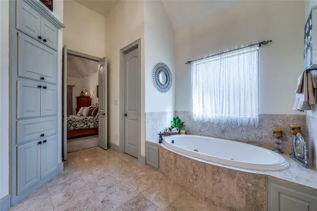 a spacious bathroom with a tub and 2 sink