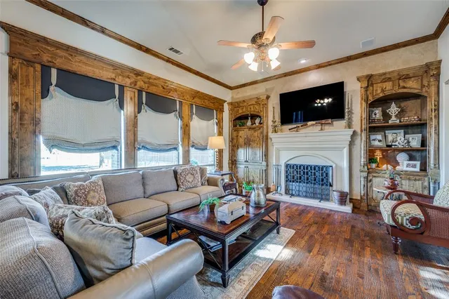 a living room with furniture a flat screen tv and a fireplace