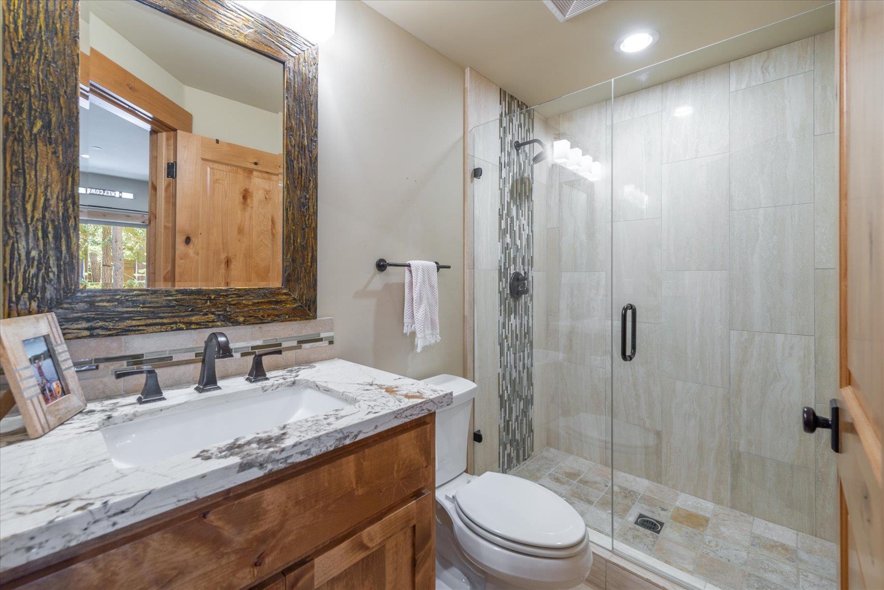 14791 Tyrol Road Truckee, CA 96161 - Photo 21 of 24 a bathroom with a granite countertop sink toilet and shower