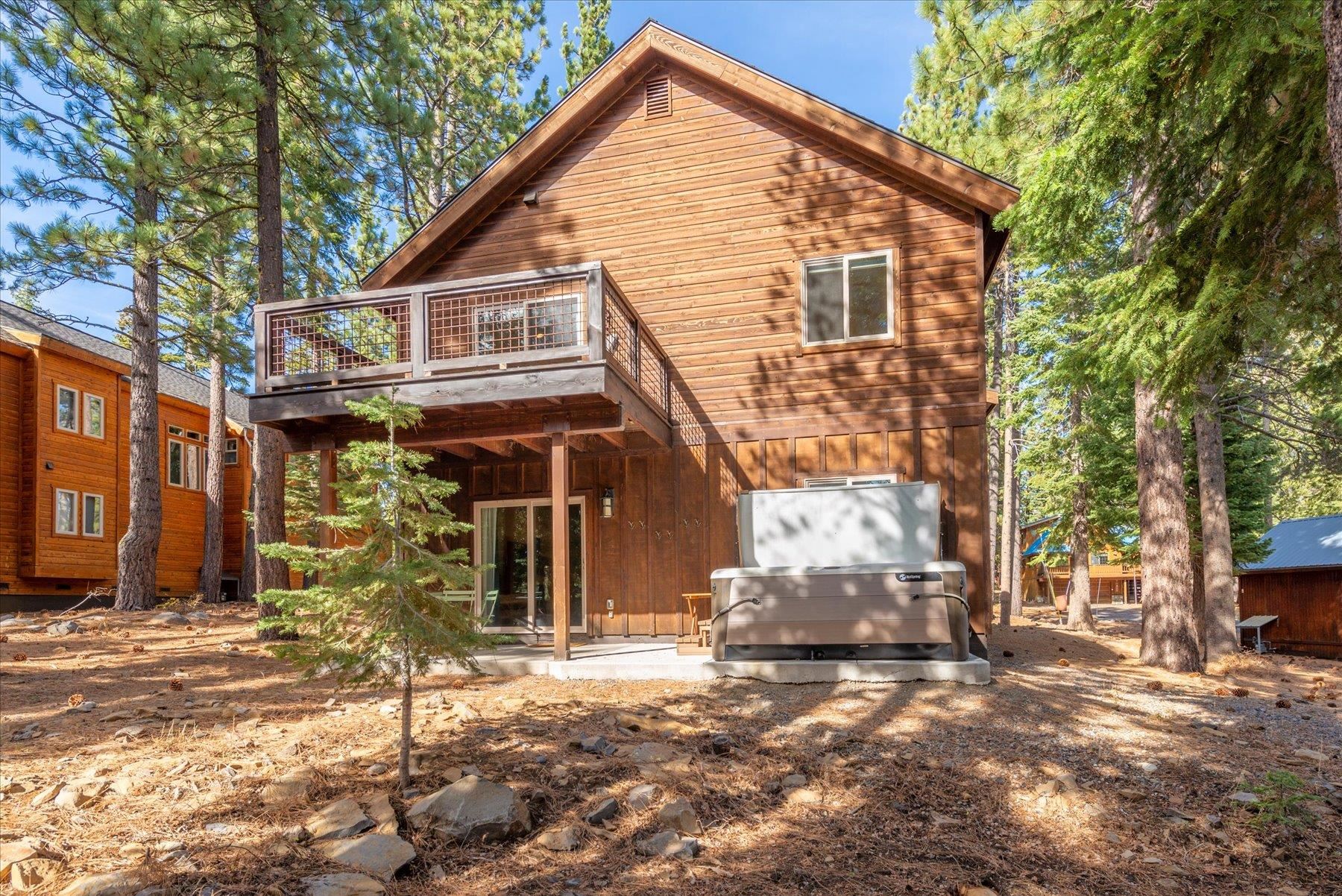 14791 Tyrol Road Truckee, CA 96161 - Photo 22 of 24 a view of a white house with large windows and a tree