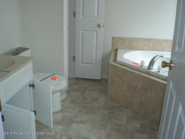 1002 Laurel Road Pocono Summit, PA 18346 - Photo 10 of 13 a bathroom with a bathtub and sink