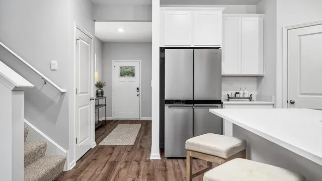 a kitchen with a refrigerator a sink and cabinets