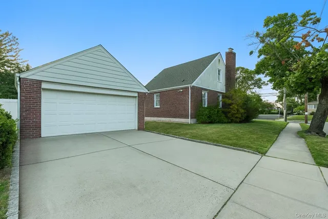 a front view of house with yard garage and green space
