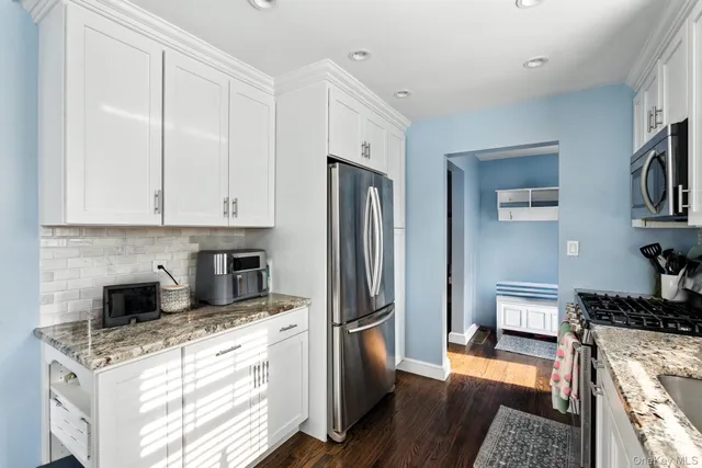 a kitchen with stainless steel appliances granite countertop a refrigerator stove and sink