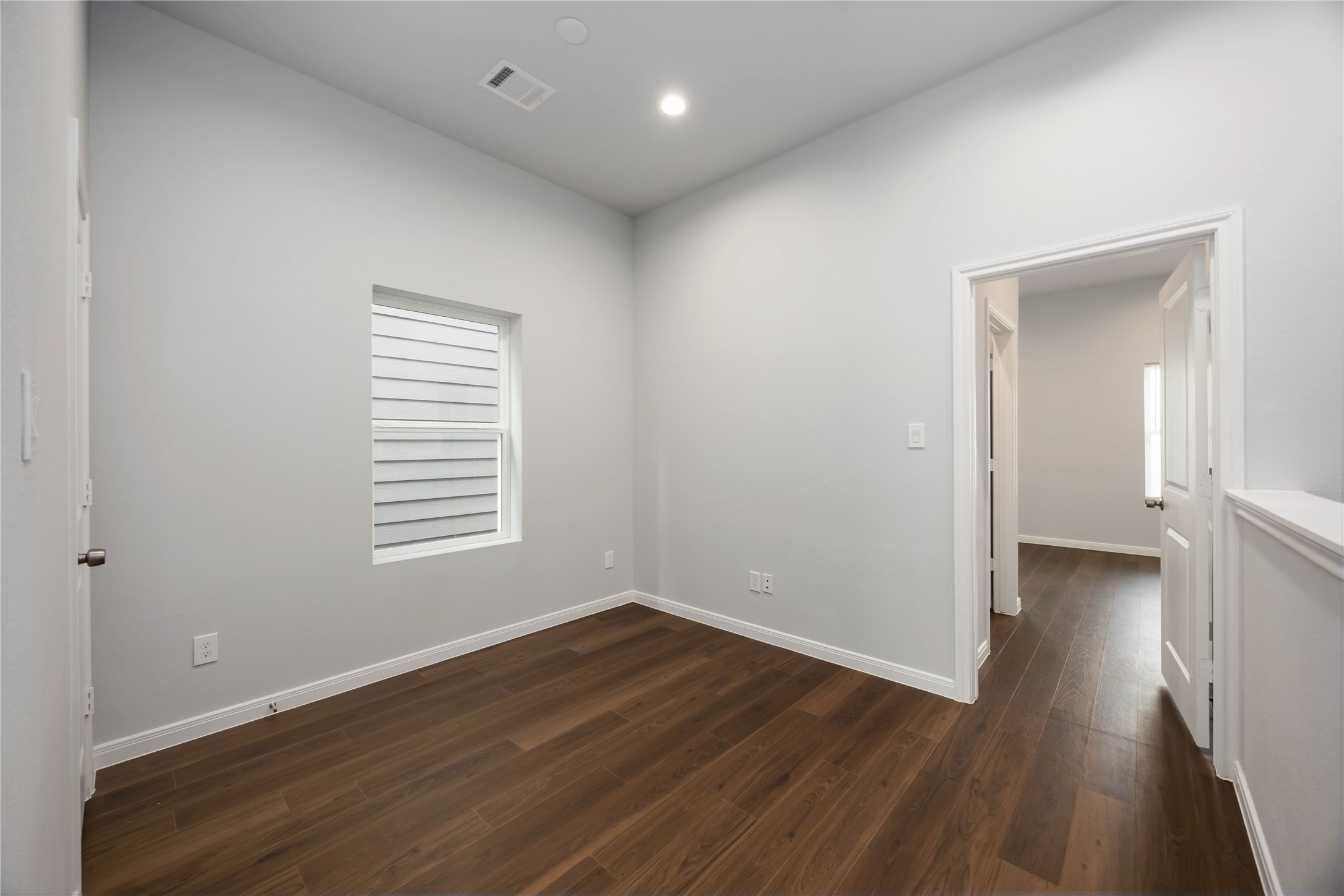 4938 Paradigm Ln Spring Spring, TX 77379 - Photo 14 of 26 a view of an empty room with wooden floor and a window
