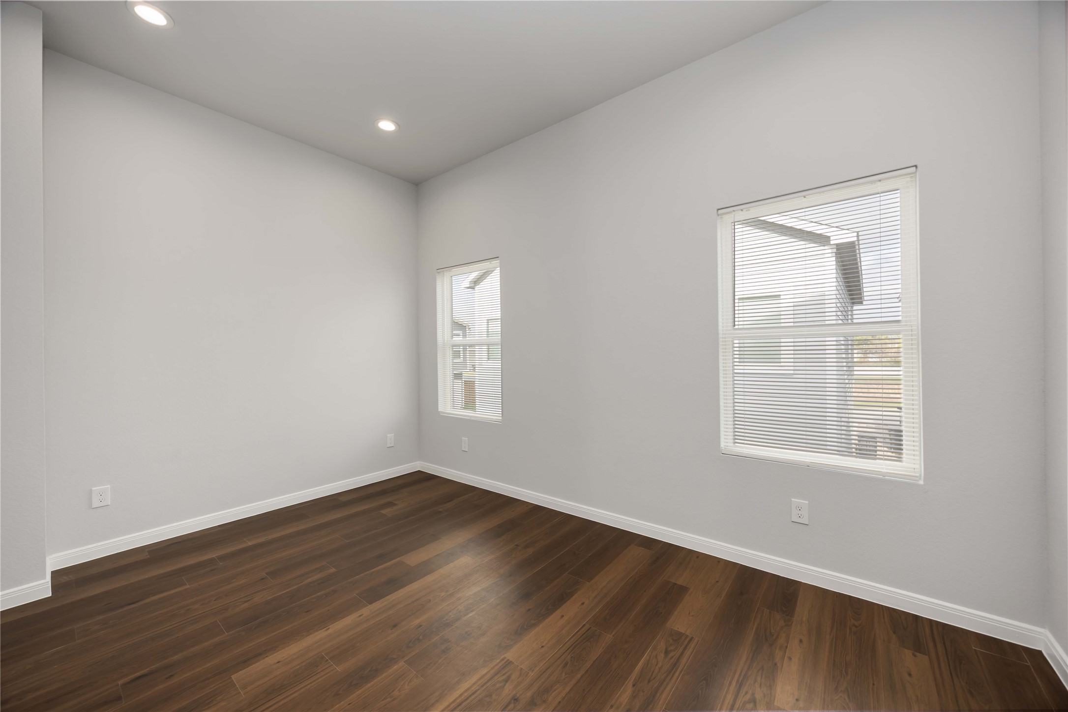 4938 Paradigm Ln Spring Spring, TX 77379 - Photo 16 of 26 an empty room with wooden floor and windows