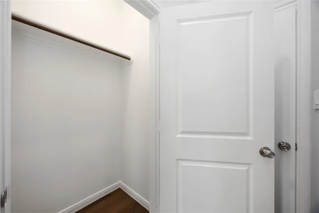 a bathroom with a granite countertop sink a toilet and a mirror