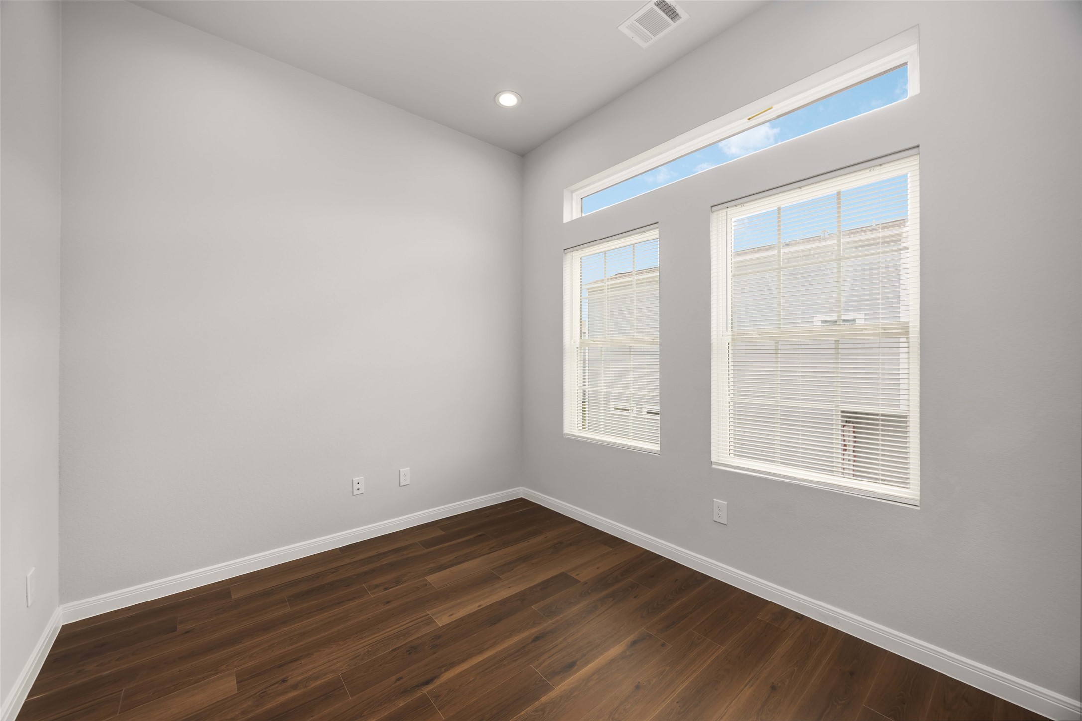 4938 Paradigm Ln Spring Spring, TX 77379 - Photo 23 of 26 an empty room with wooden floor and windows