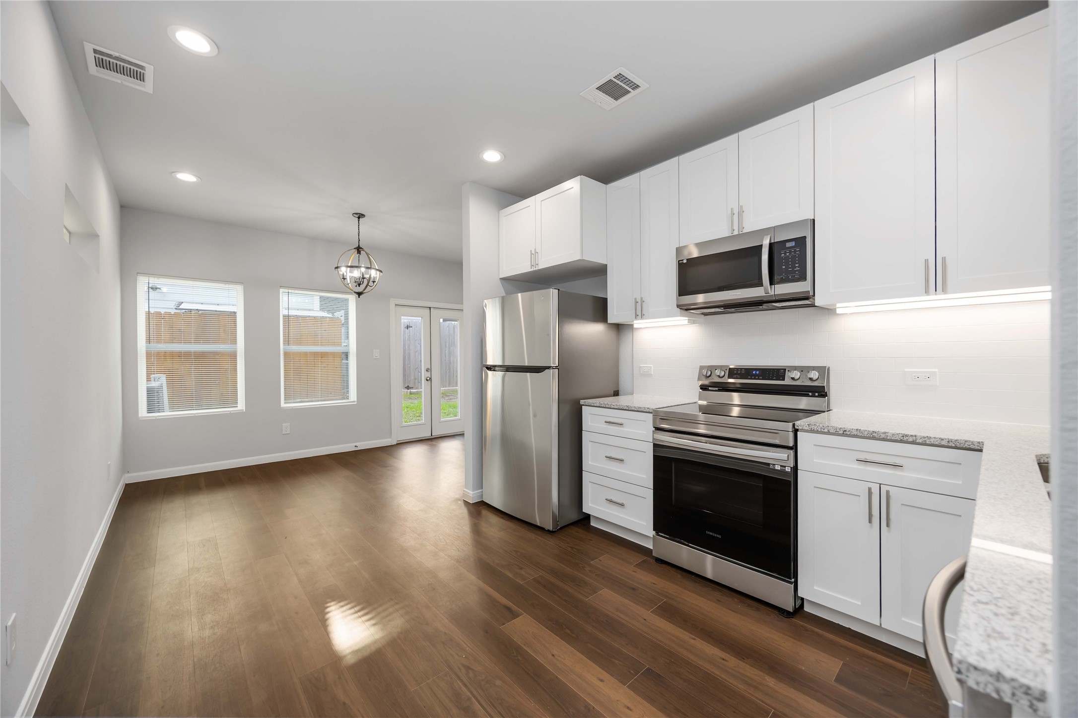 4938 Paradigm Ln Spring Spring, TX 77379 - Photo 5 of 26 a kitchen with stainless steel appliances a microwave a stove a refrigerator sink and microwave