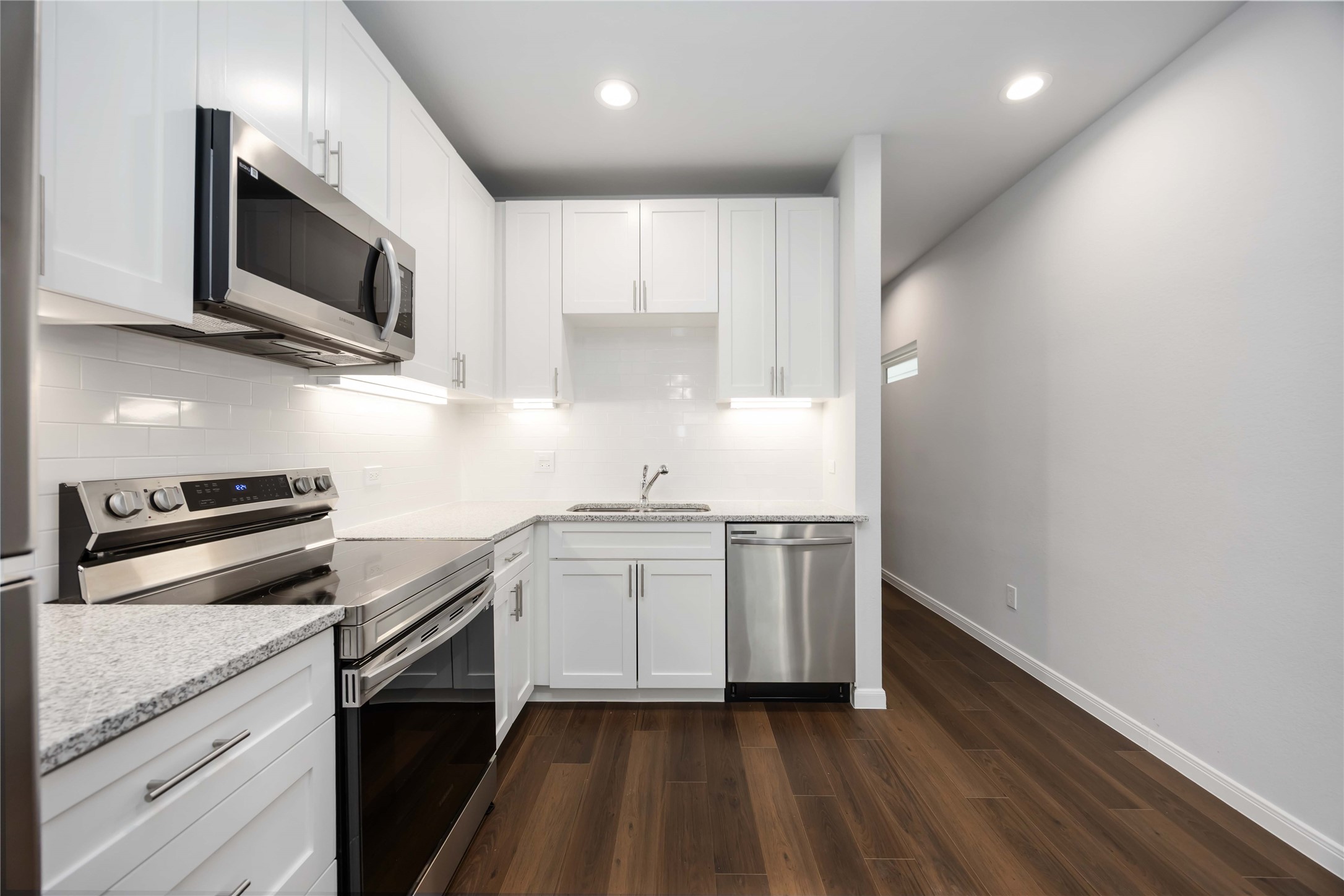 4938 Paradigm Ln Spring Spring, TX 77379 - Photo 7 of 26 a kitchen with stainless steel appliances a sink dishwasher a stove and microwave