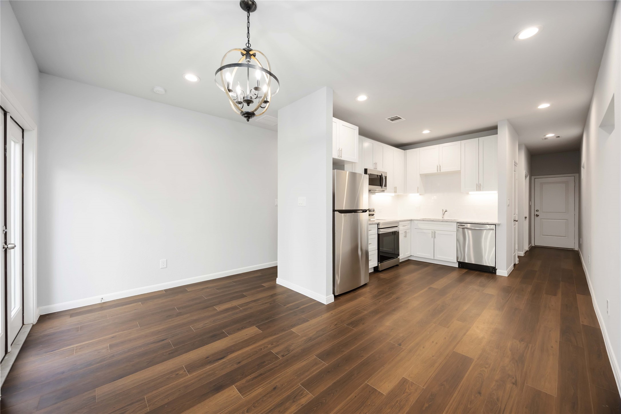 4938 Paradigm Ln Spring Spring, TX 77379 - Photo 9 of 26 a view of a kitchen with wooden floor and a window