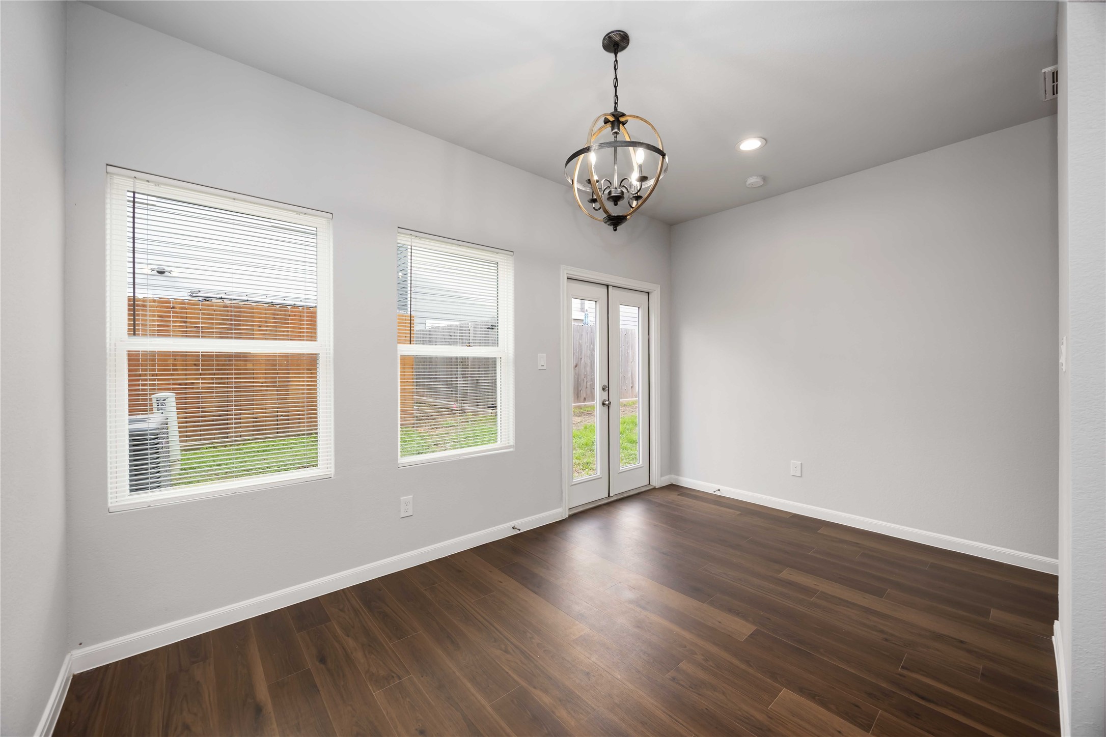 4938 Paradigm Ln Spring Spring, TX 77379 - Photo 10 of 26 an empty room with wooden floor and windows