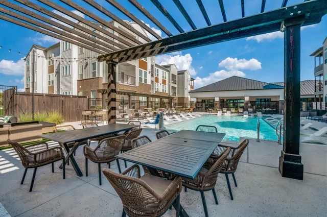 a view of a patio with a table and chairs