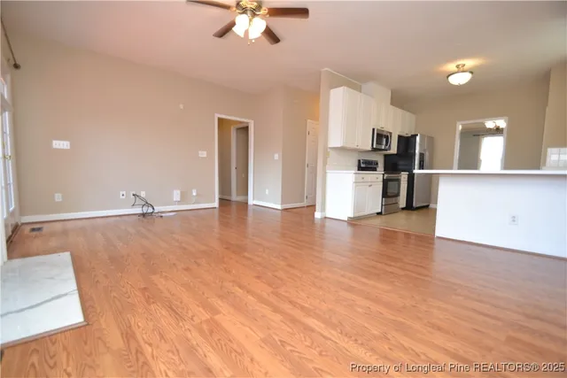 a view of a kitchen and a stove top oven