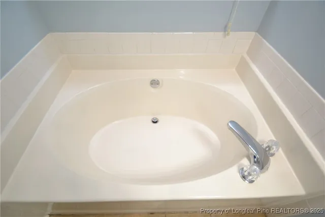 a white bath tub sitting in a bathroom