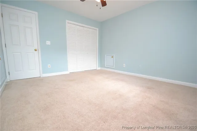 an empty room with windows and closet