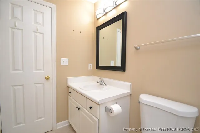 a bathroom with a sink a toilet and mirror