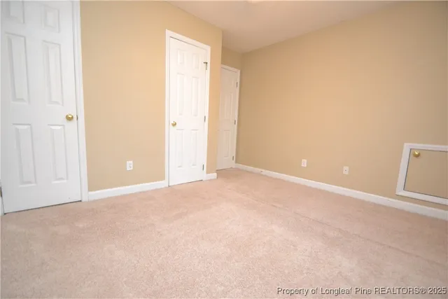 a view of an empty room and closet area