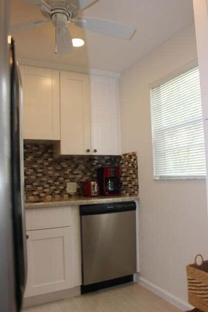 46 Mansfield B Boca Raton, FL 33434 - Photo 3 of 70 a kitchen with stainless steel appliances granite countertop a sink and a stove