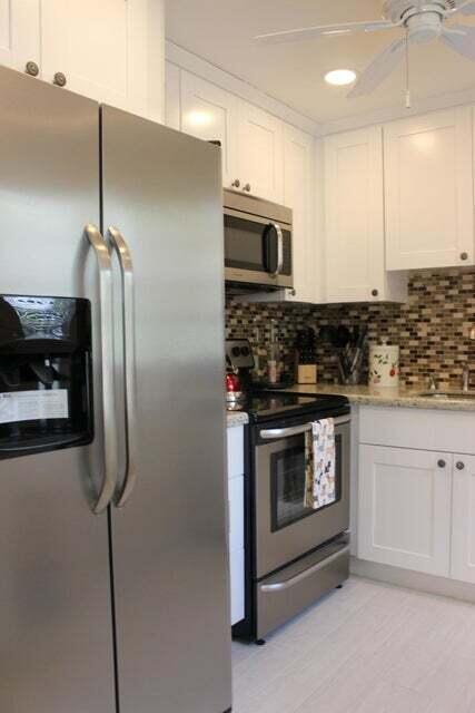 46 Mansfield B Boca Raton, FL 33434 - Photo 4 of 70 a kitchen with stainless steel appliances granite countertop a refrigerator a oven and a sink with wooden floor