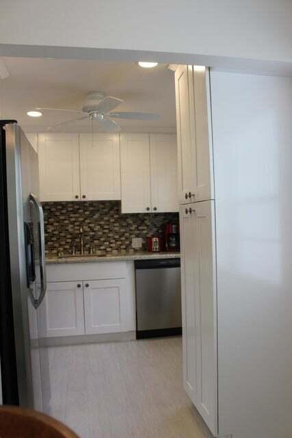 46 Mansfield B Boca Raton, FL 33434 - Photo 5 of 70 a kitchen with stainless steel appliances granite countertop a refrigerator and a stove