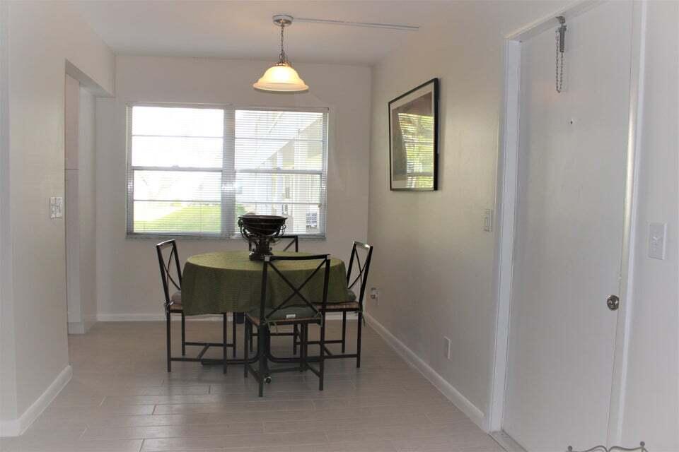 46 Mansfield B Boca Raton, FL 33434 - Photo 8 of 70 a dining room with furniture and window
